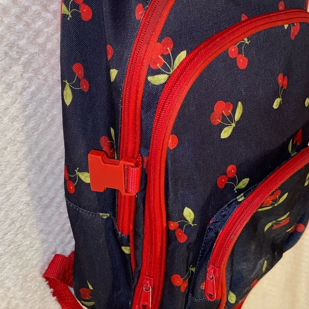 Navy blue & red cherry backpack.